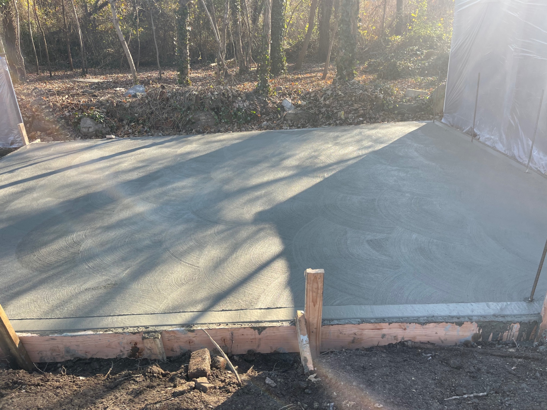 Finished broom and hand-troweled reinforced concrete pad slab