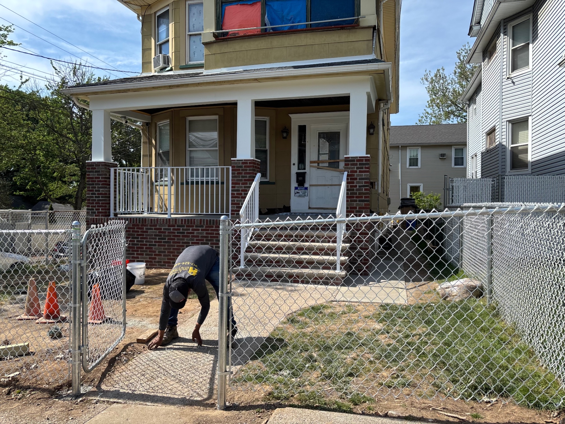 Finished brick porch restoration in Staten Island, NY with white railings