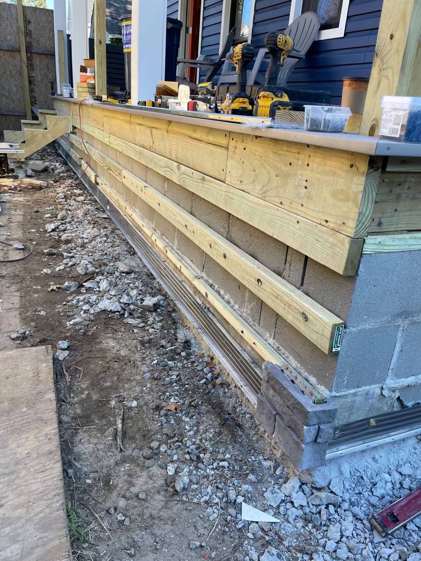 Porch base and skirting framing installed over masonry foundation before final finish details