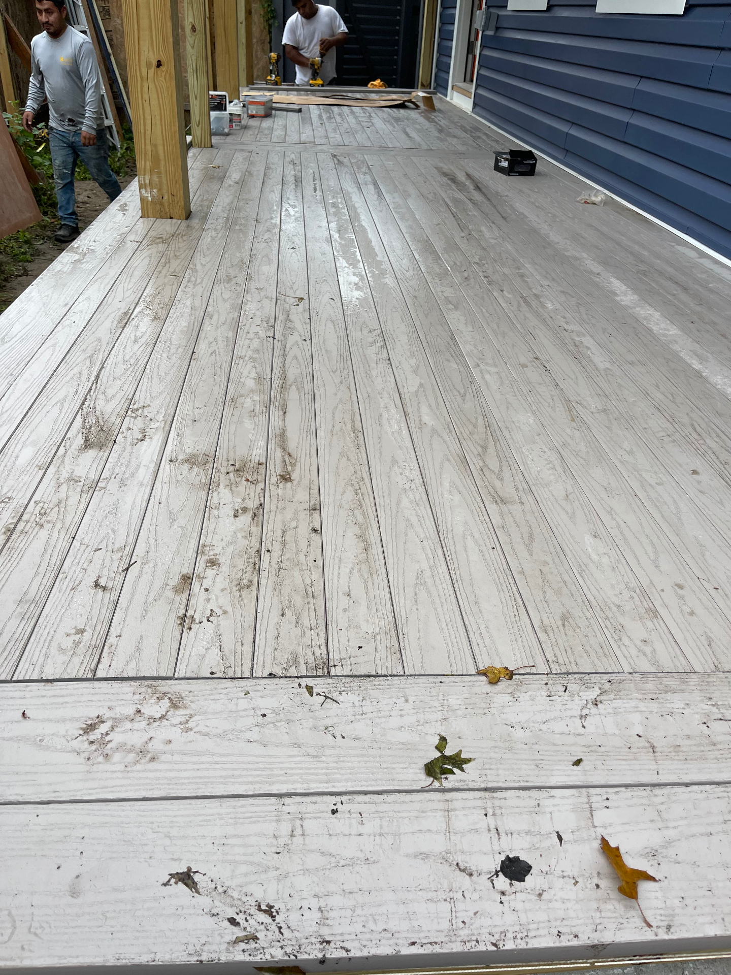 Composite porch decking installed across newly framed front porch