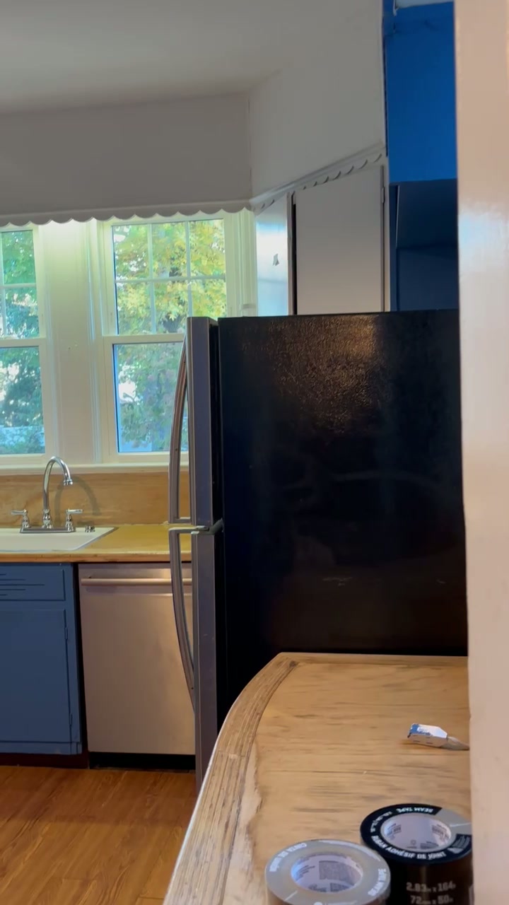 Old kitchen before remodel with outdated cabinets and counters