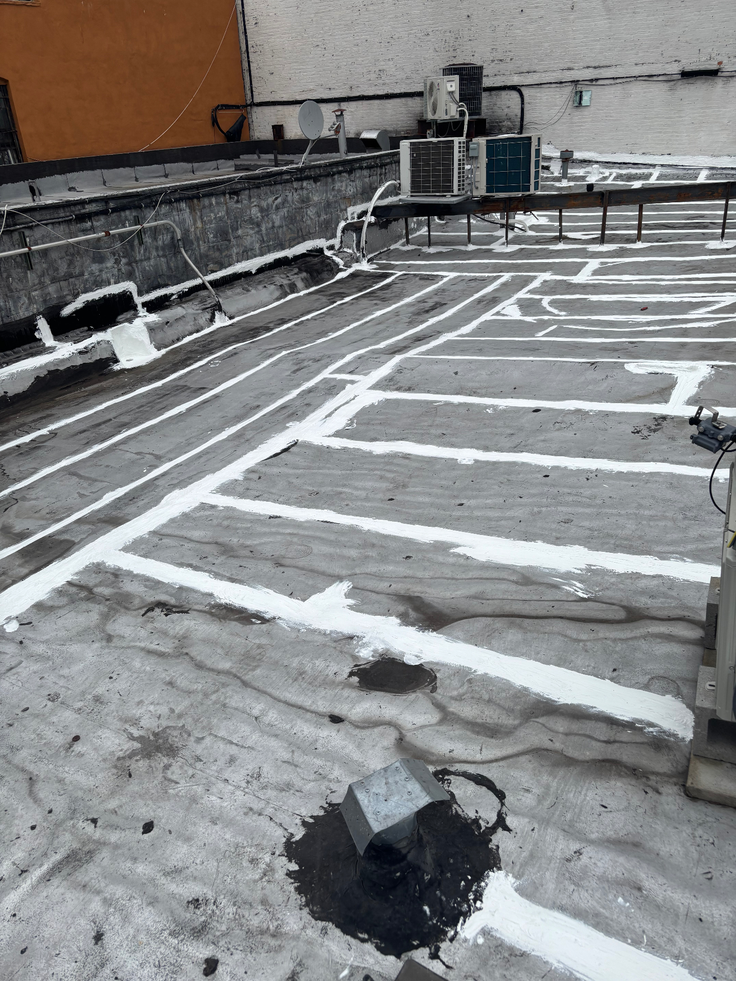 Restored Staten Island flat roof with white elastomeric coating by Affordable Handyman