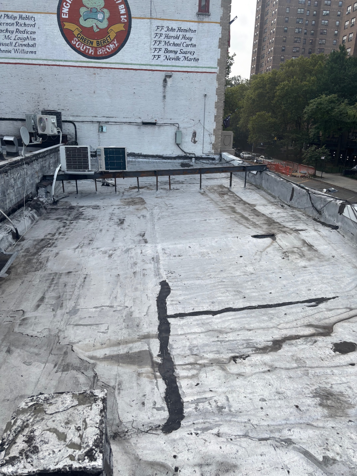 Bronx flat roof before restoration showing cracked seams, worn coating, and leaks